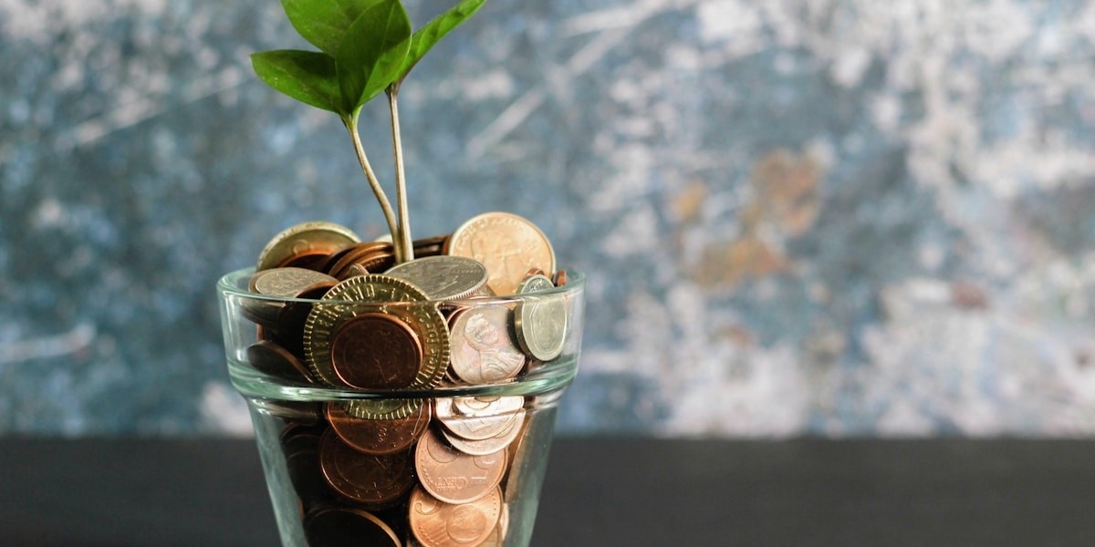 Coins, notebook and calculator illustrating layered passive income