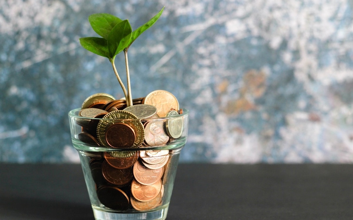 Coins, calculator and notebook representing passive income stack