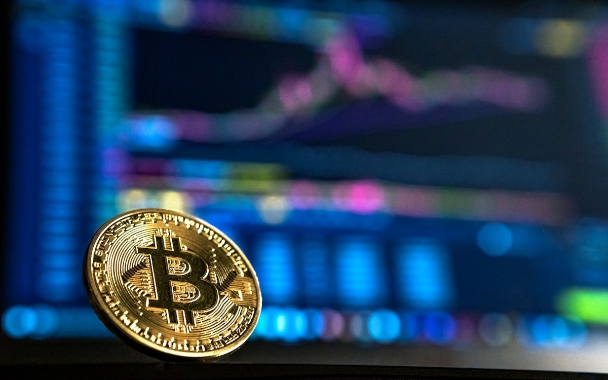 Bitcoin and digital asset charts on a glowing screen